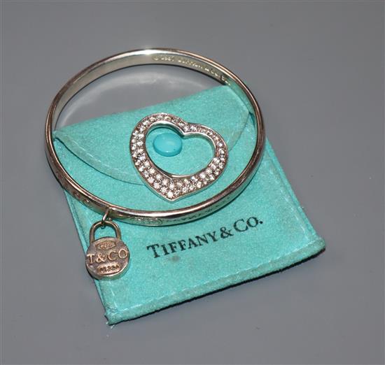 A Tiffany & Co 925 bangle and a 925 heart shaped pendant set with white stones.